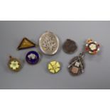 A Victorian silver locket and a silver rifle medal, enamel badges, etc.