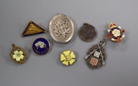 A Victorian silver locket and a silver rifle medal, enamel badges, etc.