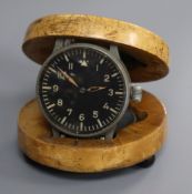 A military timepiece in maple case/stand