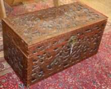 A Cantonese camphor wood chest, carved with dragons and stylised clouds W.101cm