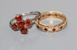 An 18ct white gold and five-stone hessonite garnet set cluster ring and a 9ct gold, ruby and diamond