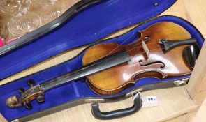 A German 19th century violin with two-piece back, faux Guadagnini label and carved lion's head