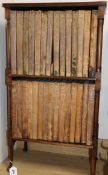 A bookshelf containing leather bound books, 29 volumes