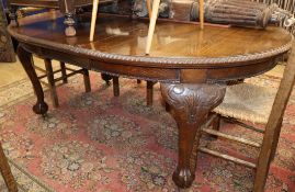 A Chippendale style oak extending dining table with one spare leaf W.190cm