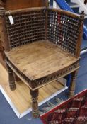 A 19th century carved hardwood corner chair