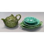 A green leaf teapot and a collection of similar plates, dishes and a bowl