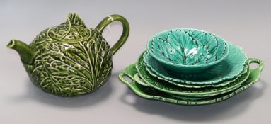 A green leaf teapot and a collection of similar plates, dishes and a bowl