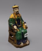 A Chinese seated figure of a mandarin 24cm high