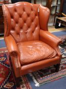 A leather wing back armchair