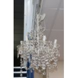 A six branch white painted electrolier with hung cut glass drops