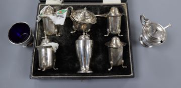 A 1930's Art Deco silver three piece condiment set and a cased George V silver five piece