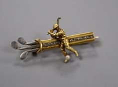 An early/mid 20th century yellow and white metal, rose cut diamond set golfer and golf bag bar