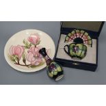 A Moorcroft vase, a plate and cased teacup and saucer