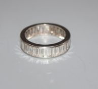 A white metal and baguette cut diamond full eternity ring, set with twenty nine stones, size N/O.