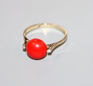 A 750 yellow metal, coral and diamond three stone ring, size O.