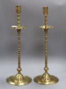 A pair of Benares brass candlesticks height 58cm