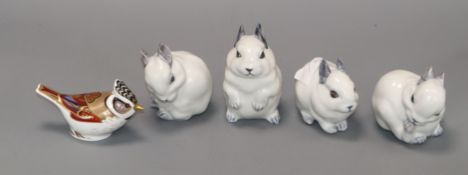 Four Royal Copenhagen rabbits and a Derby bird paperweight