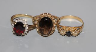 Three assorted 9ct gold and gem set dress rings.