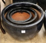 Three black glazed garden pots largest W.52cm