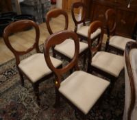 A set of six Victorian walnut balloon-back dining chairs