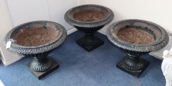 Three cast iron garden urns