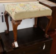 A walnut dressing stool, with claw and ball feet W.59cm