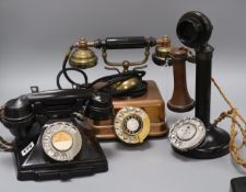 A candlestick phone, a brass telephone and a bakelite telephone