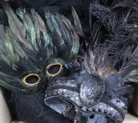 A collection of feather masks, a cape / collar etc.