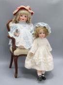 A Heubach Koppelsdorf 320 doll, an Armand Marseille 390 doll and a doll's chair