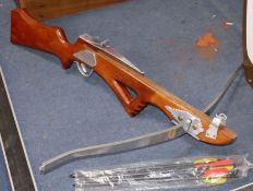 A hardwood and stainless steel crossbow and bolts