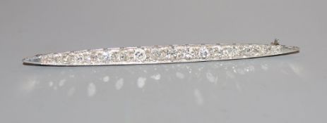 A mid 20th century white metal and graduated diamond set bar brooch, 76mm.