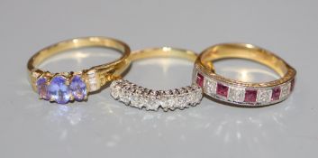 A modern 18ct gold diamond, ruby and diamond seven stone half hoop ring, an 18ct gold, tanzanite and