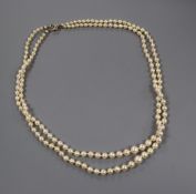 A twin strand graduated cultured pearl necklace with yellow metal and four stone diamond set