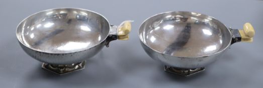 A stylish pair of George V Art Deco ivory handled circular bonbon dishes by Charles Boyton & Sons