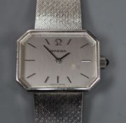 A lady's 9ct white gold Omega manual wind wrist watch, on a 9ct white gold Omega bracelet, with