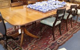 A William Tillman George III style two-pillar dining table having two additional leaves L 253cm