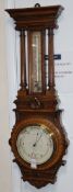 A Victorian carved oak aneroid barometer with thermometer H.92cm