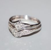 A modern 18ct white gold and diamond set wedding and engagement ring set, set with round and