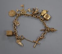A 9ct gold charm bracelet hung with seven assorted charms including 9ct gold.