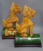 A pair of Chinese earthenware ridge tiles on stands height 46cm