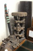 A Tribal mask, a carved pillar and wooden umbrella stand and a tribal sword