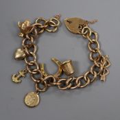 A 9ct gold charm bracelet hung with seven assorted charms including 9ct gold coffee pot.