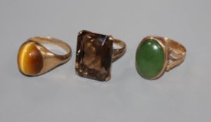 A 9ct gold and quartz dress ring, a similar tiger's eye quartz ring and a 9ct and green cabochon