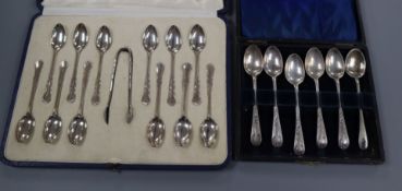 A cased set of 1920's twelve silver coffee spoons and tongs and a cased set of six silver