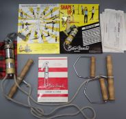 A vintage American made Exer-Genie exerciser with original manual and receipt