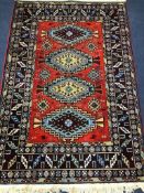 A Caucasian design red ground rug, 180 x 126cm