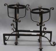 A pair of wrought iron fire dogs