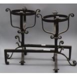 A pair of wrought iron fire dogs