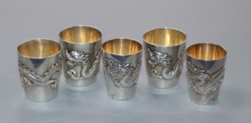 Five Chinese silver dragon cups, early 20th century, 3 by Wang Hing and two by Tuk Chang & Co.