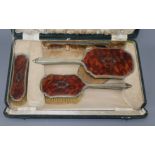 A cased plated and tortoiseshell brush set